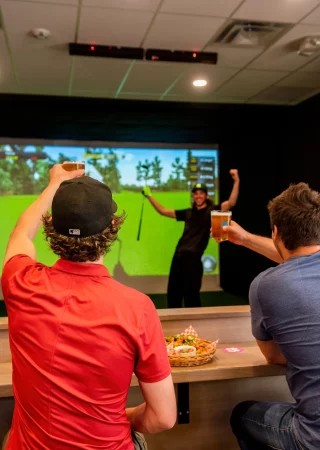 Guests enjoying the indoor golf experience